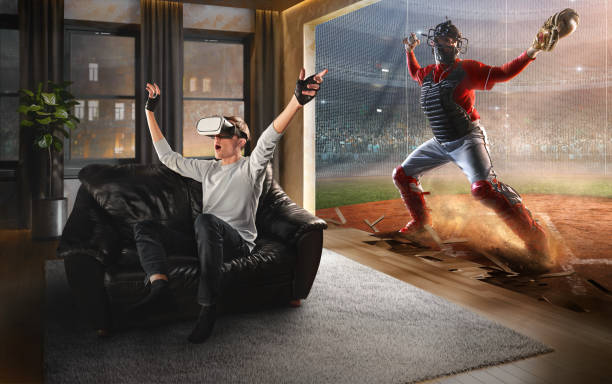 Man in VR Glasses. Virtual Reality with Baseball Young man at home on a black sofa with VR headset emotionally playing in virtual reality Baseball virtual reality point of view stock pictures, royalty-free photos & images