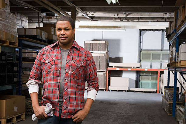 Man in warehouse  plaid shirt stock pictures, royalty-free photos & images