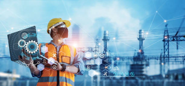 Man industrial engineer using Laptop computer checking and analysis data of power plant station project on blue background. stock photo
