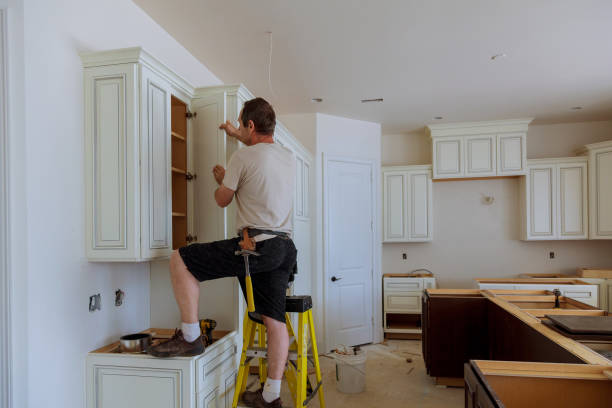 Man installing kitchen cabinets door Man installing kitchen cabinets door installation of kitchen cabinet stock pictures, royalty-free photos & images