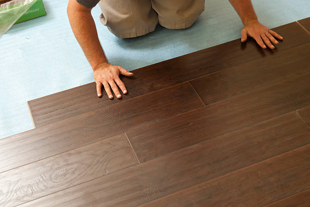 Man Installing New Laminate Wood Flooring stock photo
