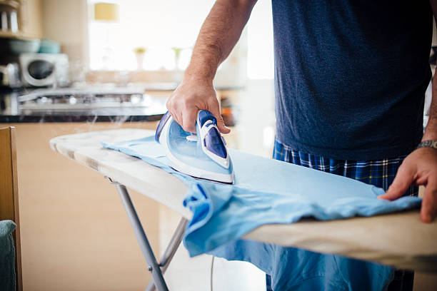 Man Ironing Laundry stock photo