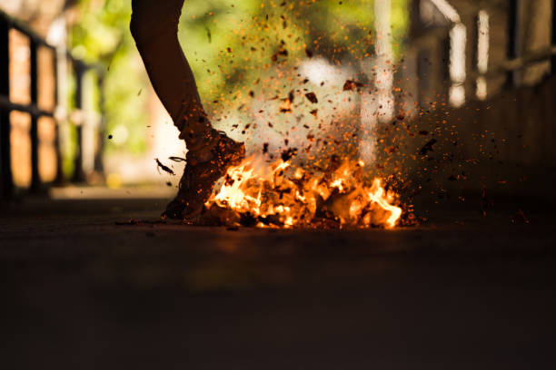 A man is kick the bonfire. A man is kick the bonfire. firewalking stock pictures, royalty-free photos & images