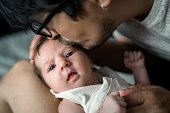 istock Man kissing his baby girl 1367707587