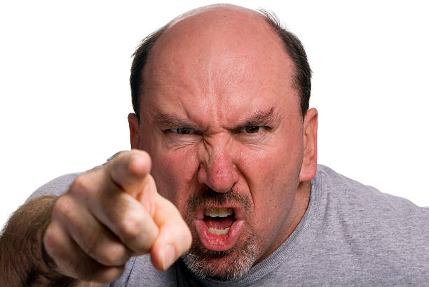 A man looking angry and pointing stock photo