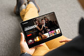 istock Man looking TV series and movies on his digital tablet 1288375703