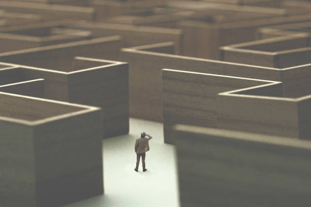 man lost in a complex maze, surreal concept stock photo