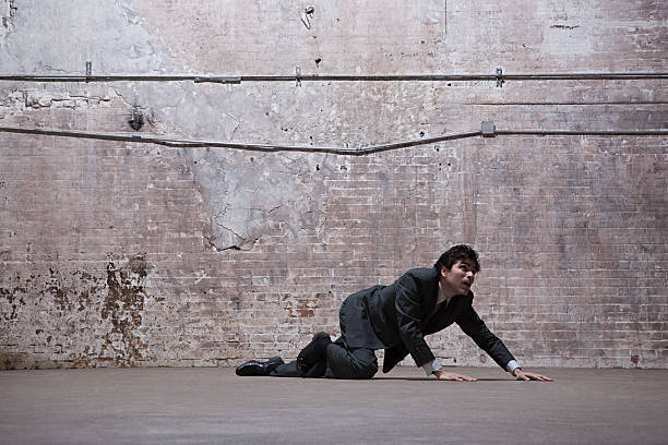 Man lying on warehouse floor  crawling stock pictures, royalty-free photos & images