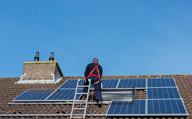 man making construction with solar panels stock photo