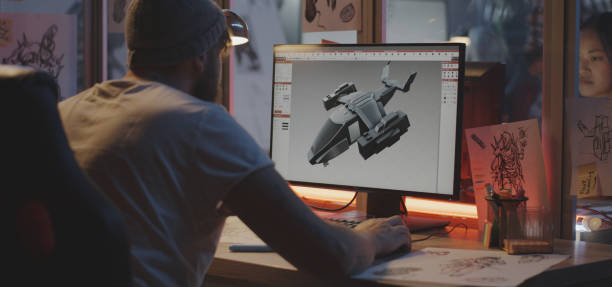 コンピュータ上の飛行機をモデル化する男 - デザイナー ストックフォトと画像