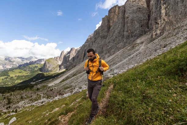 Man mountain hiking on the Dolomites: outdoor adventure Man mountain hiking on the Dolomites: post pandemic outdoor adventure rangers stock pictures, royalty-free photos & images