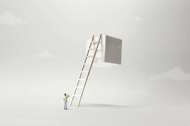 man observing white solid cube suspended in the air, surreal concept stock photo