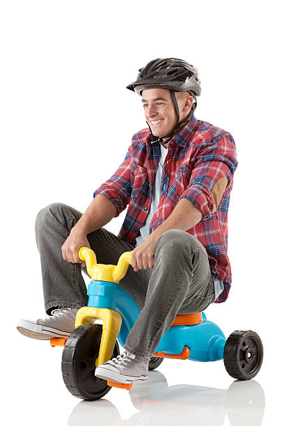 Man on a tricycle Man on a tricycle adult tricycle stock pictures, royalty-free photos & images