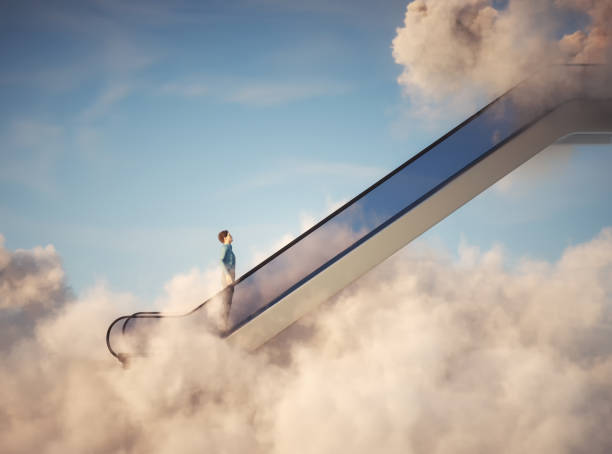 Man on escalator above clouds. Aspirations and promotion concept. stock photo