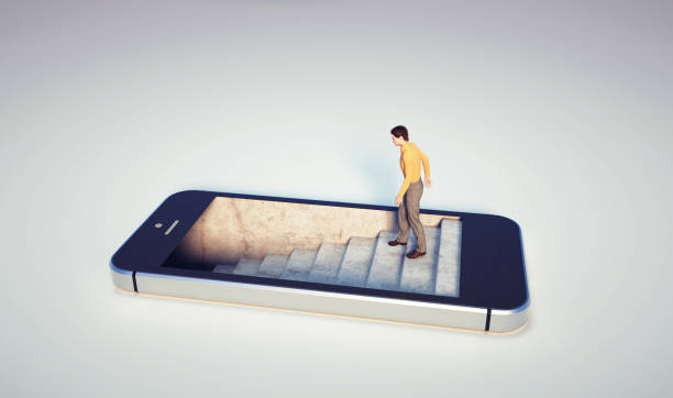 Man on stairs inside a smartphone. stock photo