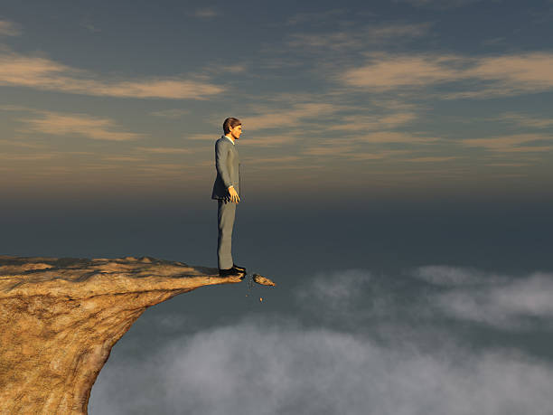 Man on the edge of a cliff stock photo