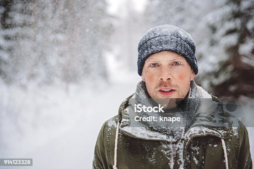 istock Man out in nature during snowy day in winter 914123328