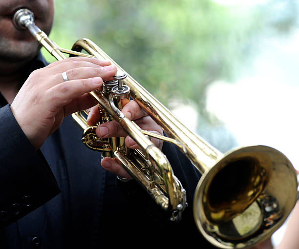 Man playing his trumpet outside stock photo