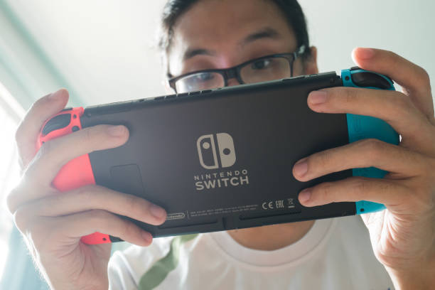 A man playing Nintendo Switch. stock photo
