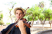 Portrait of a man playing violin outside
