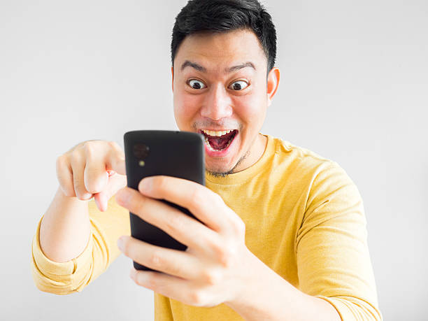 Man plays mobile game. stock photo