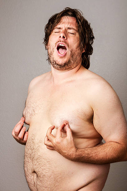 Man pleasuring his own nipples stock photo