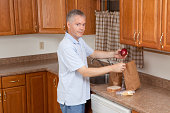 Man in kitchen preparing healthy brown bag school or work lunches.Please also see: