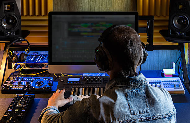 Man produce electronic music in studio Man produce electronic music in project home studio. producer stock pictures, royalty-free photos & images