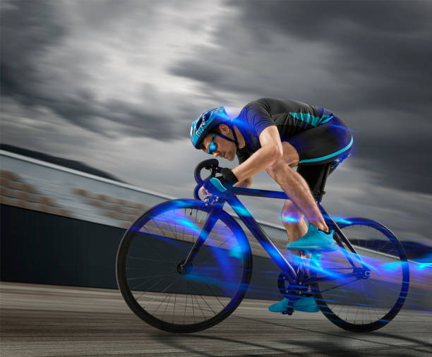 Man racing cyclist in motion on track background stock photo