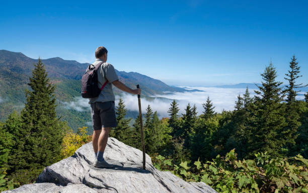 Man relaxing on hiking trip in the mountains. stock photo