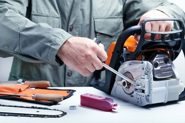 Man repairing chainsaw. stock photo
