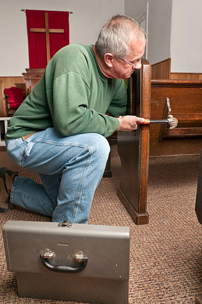 Man repairing church pews stock photo