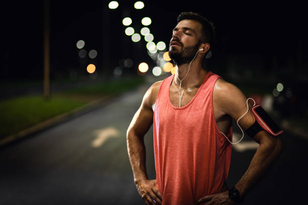 Man resting after night workout in the city. in the night stock pictures, royalty-free photos & images