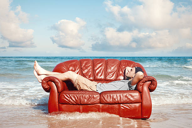 man resting on the beach stock photo