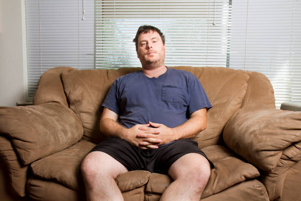 man resting on the couch stock photo