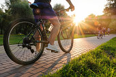 istock Man rides a bike outdoors in the park on a sunny day at sunset 1340571998