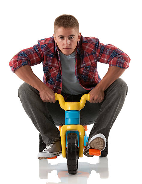 Man riding a tricycle Man riding a tricycle adult tricycle stock pictures, royalty-free photos & images