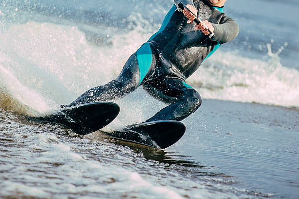 man riding on water skis stock photo