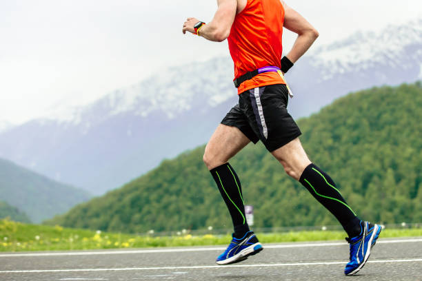 man runner in compression socks stock photo