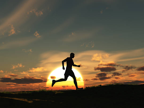 Man running at dawn stock photo