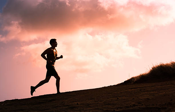 Man running outdoors Fitness male running outdoors during sunset. Healthy lifestyle concept.  cross country running stock pictures, royalty-free photos & images
