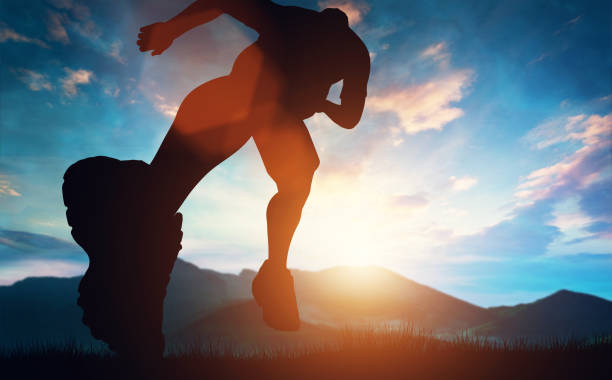 山の夕日に向かって走っている人 - 走る ストックフォトと画像