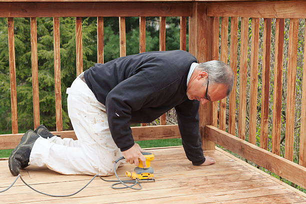 Man Sanding an Outdoor Deck 