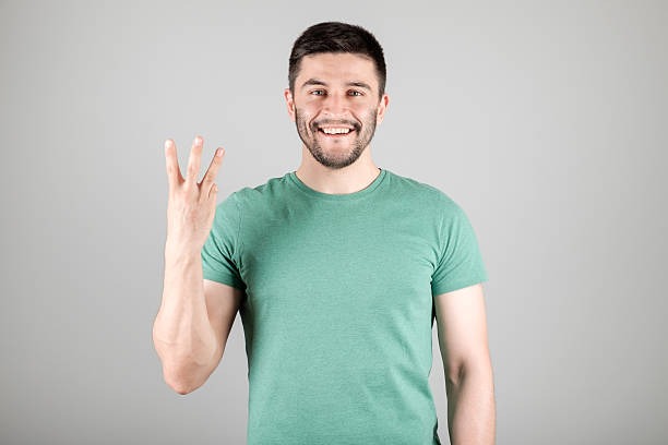 Man showing number by fingers stock photo