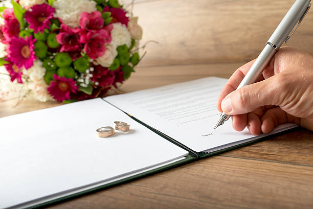Man signing a marriage register stock photo