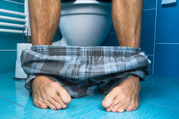 A man sit on the toilet. A man sit on the toilet. sit on toilet stock pictures, royalty-free photos & images