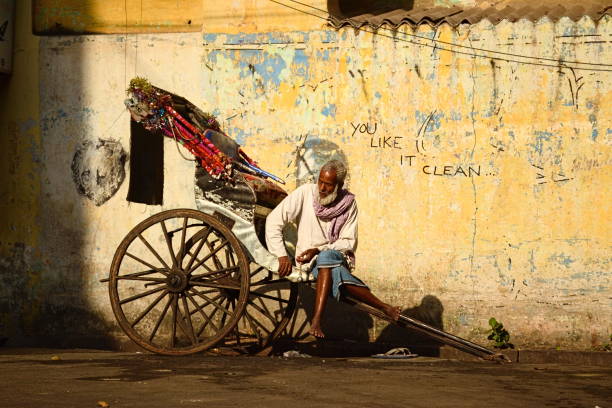 Man sitting on his rickshaw in Kolkata stock photo