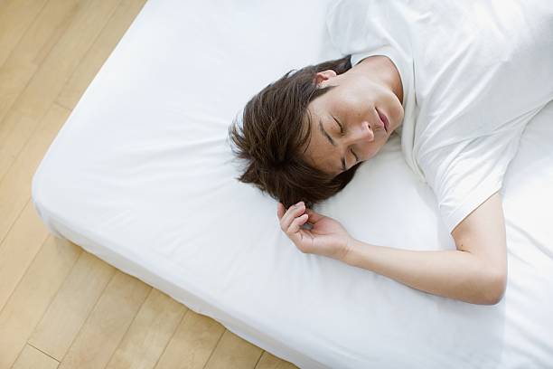 Man sleeping  man sleeping in bed top view stock pictures, royalty-free photos & images