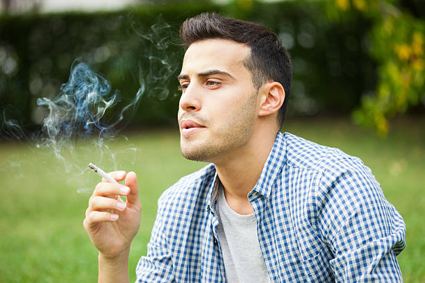 Man smoking a cigarette stock photo
