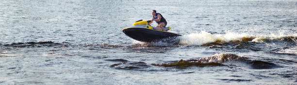 man speeding on jet ski on lake during summer vacation - vattenskoter motor bildbanksfoton och bilder